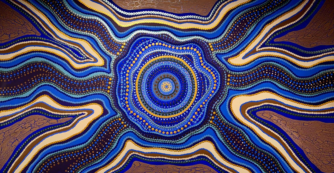 Beneath The Surface, an original painting by Taminga Connell: concentric dotted circles at the centre with blue, ochre and cream bands radiating outward.