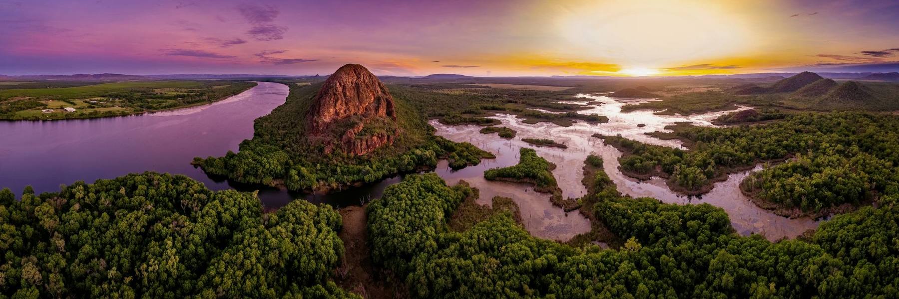 Sunrise over the Sleeping Buddha, river channels and wetlands spreading out below.